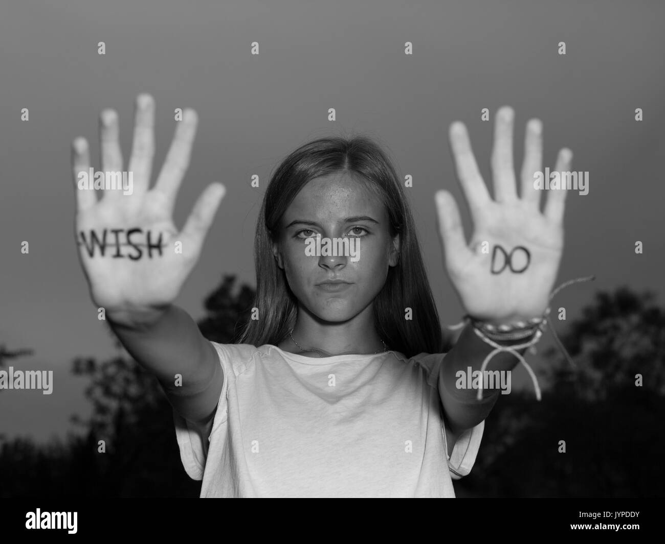 Teenage Girl hold up hands with motivational quotes written on palms. Stock Photo