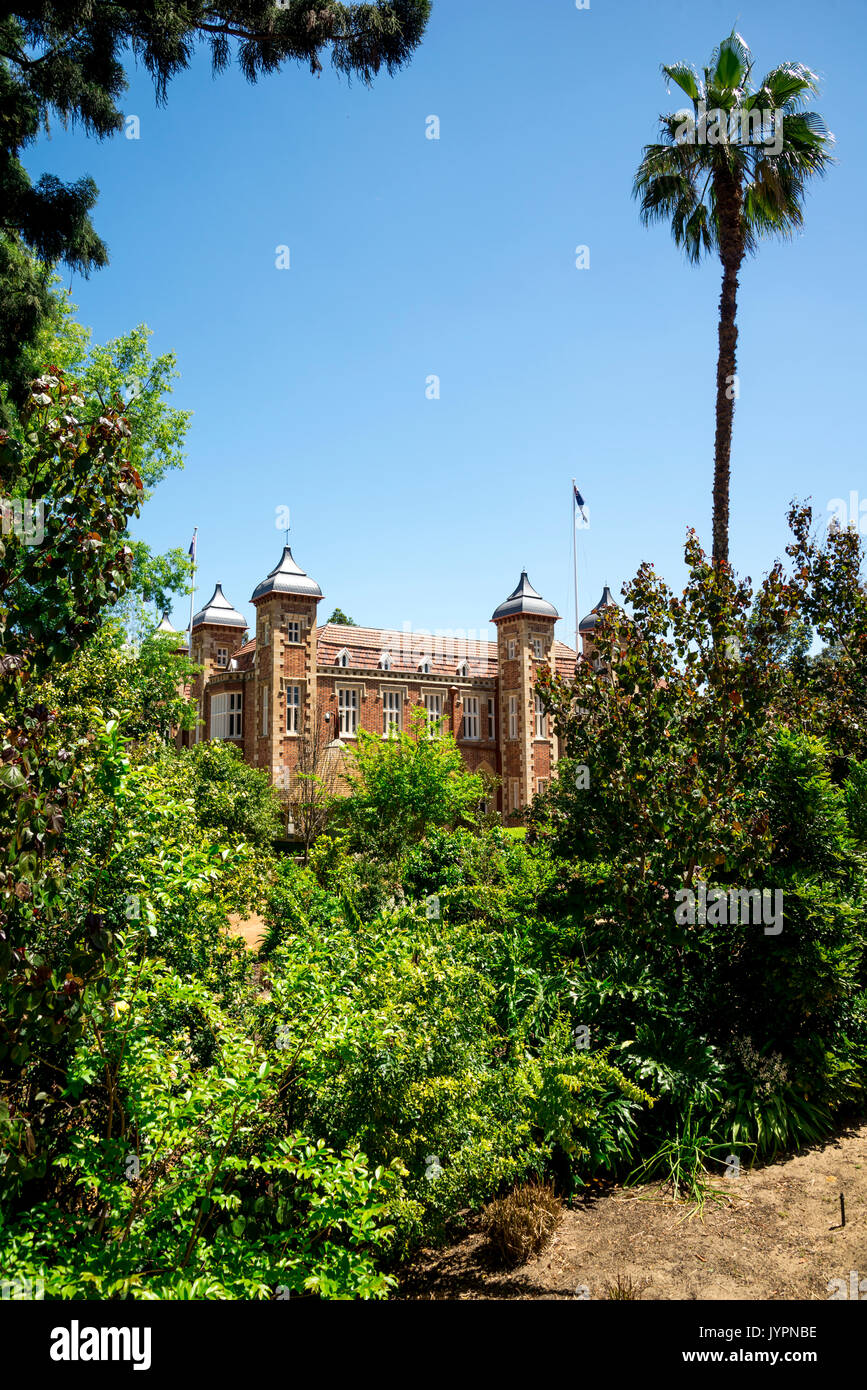 Government House hiding behind trees in Perth City centre, Western Australia Stock Photo
