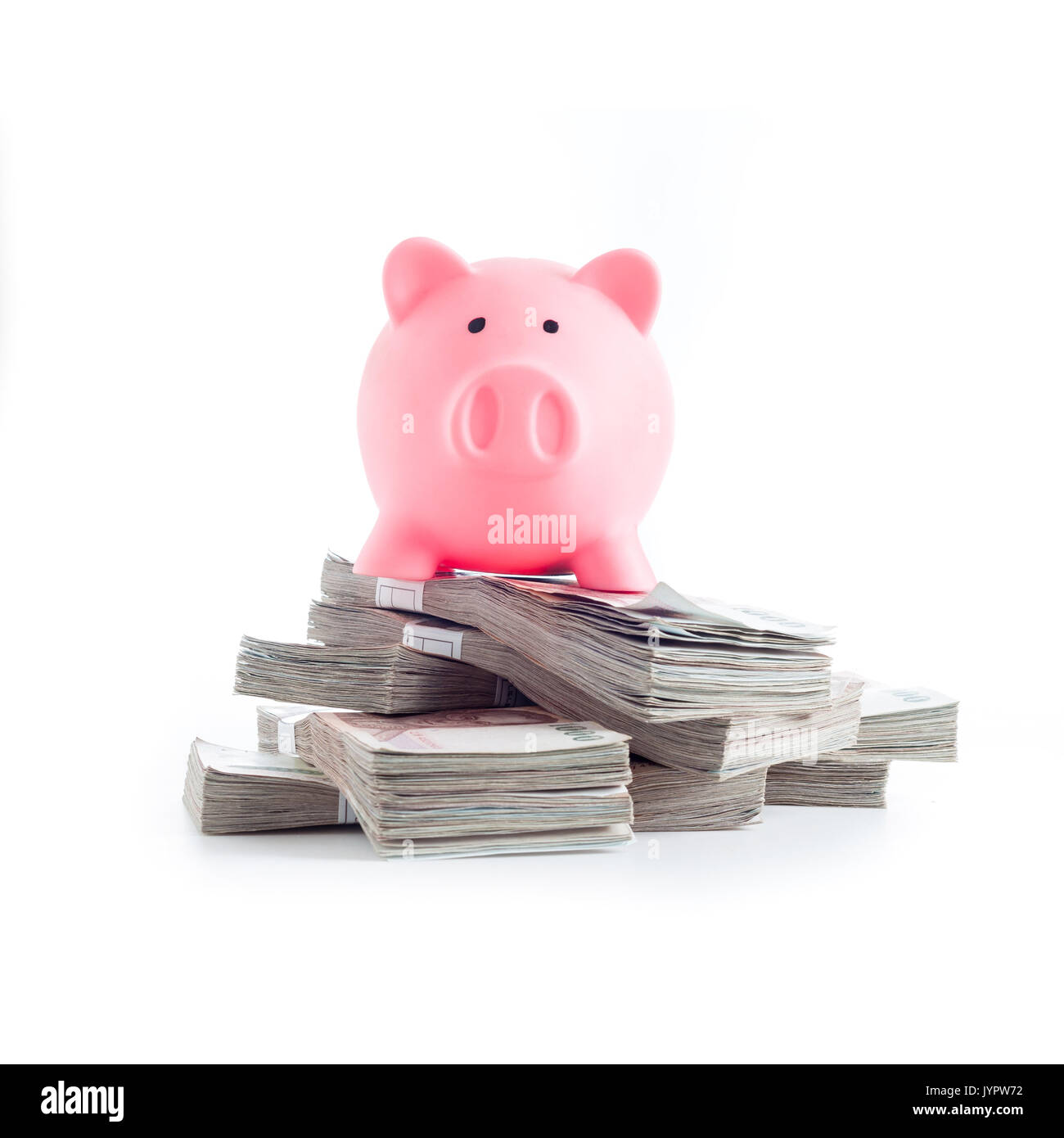Pink piggy bank on heap of banknotes of Thailand. Investment or Good income concept Stock Photo