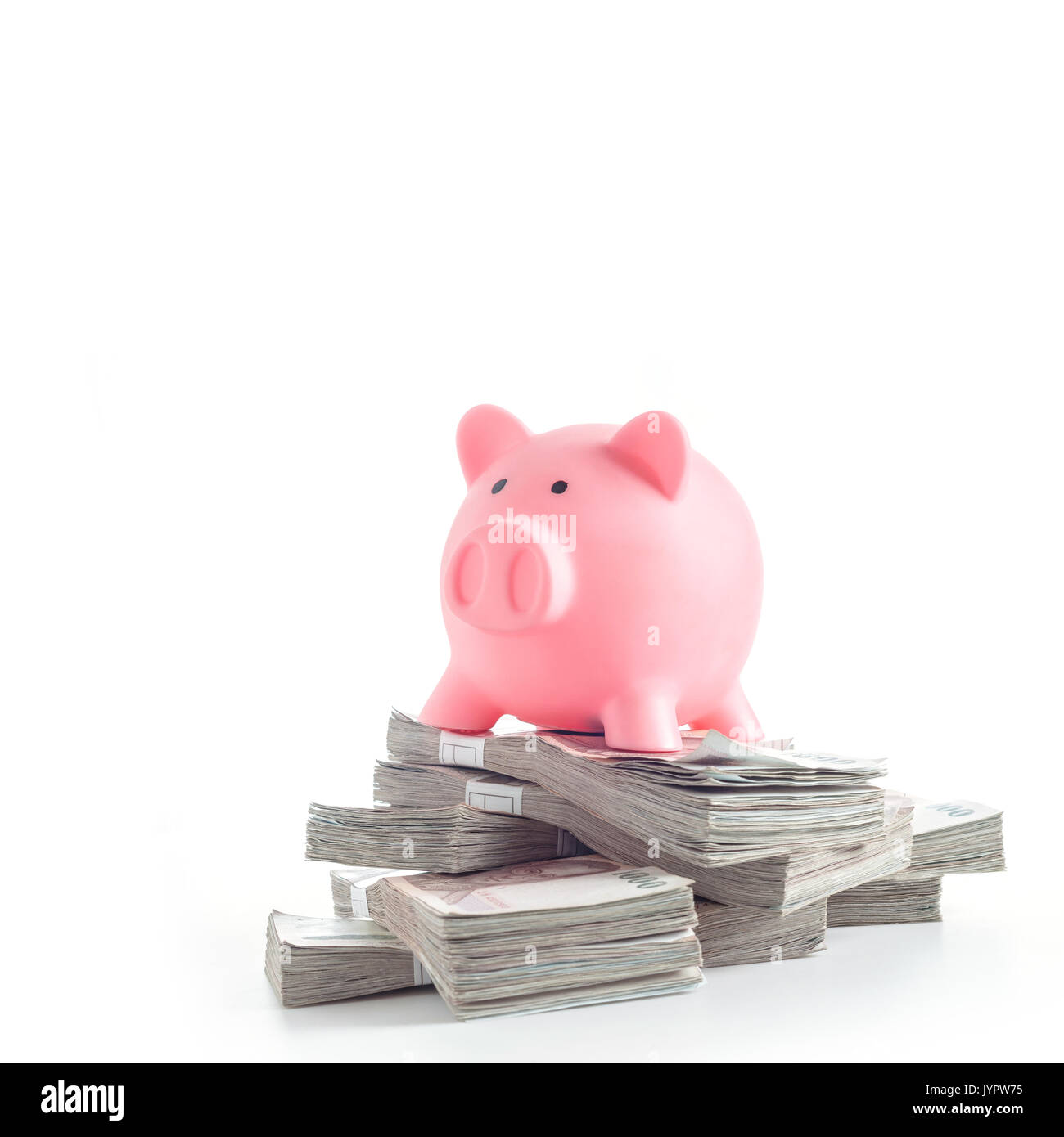 Pink piggy bank on heap of banknotes of Thailand. Investment or Good income concept Stock Photo