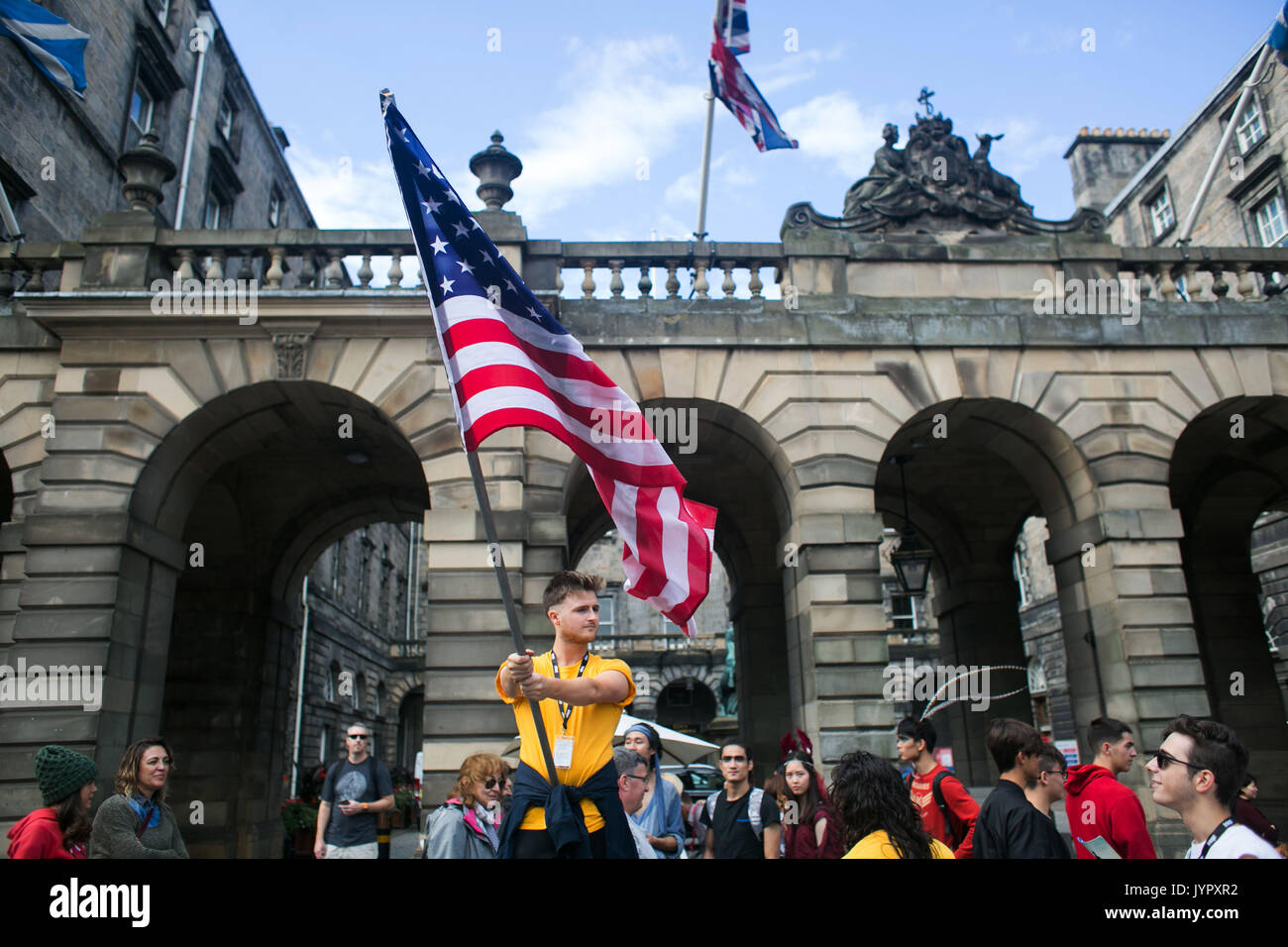 Performers advertise their next show in the Royal Mile with the American flag. Edinburgh international and fringe festival in full swing. Stock Photo