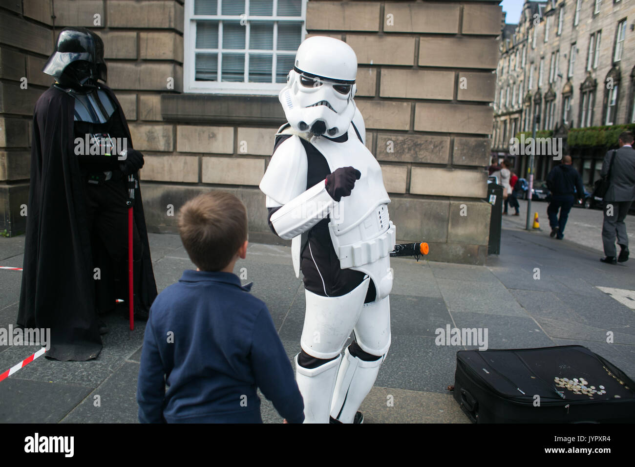 Buskers in the Royal Mile perform as Star Wars Storm troopers and Darth Vader. Edinburgh international and fringe festival in full swing. Stock Photo