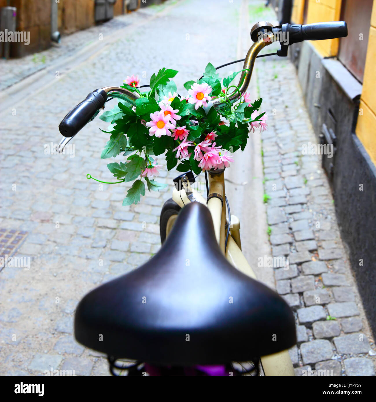 Bicycle with bunch of flowers on handle bar in Stockholm, Sweden. Shallow DOF! Stock Photo