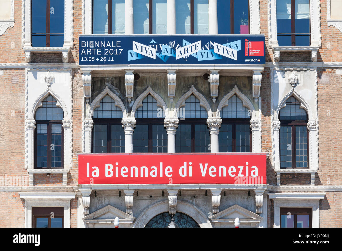 The Biennale di Venezia sign on the front of their offices in Venice, Veneto, Italy together with the  sign with their artwork  for the 2017 event dis Stock Photo