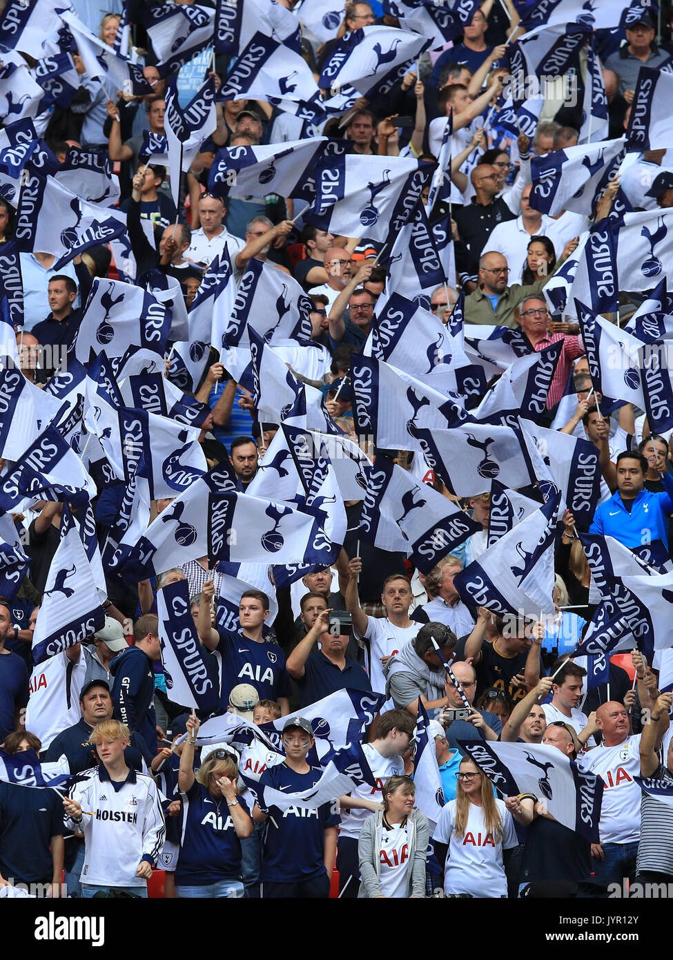 Tottenham Hotspur fans wave flags in the stansd during the Premier League  match at Wembley Stadium, London Stock Photo - Alamy