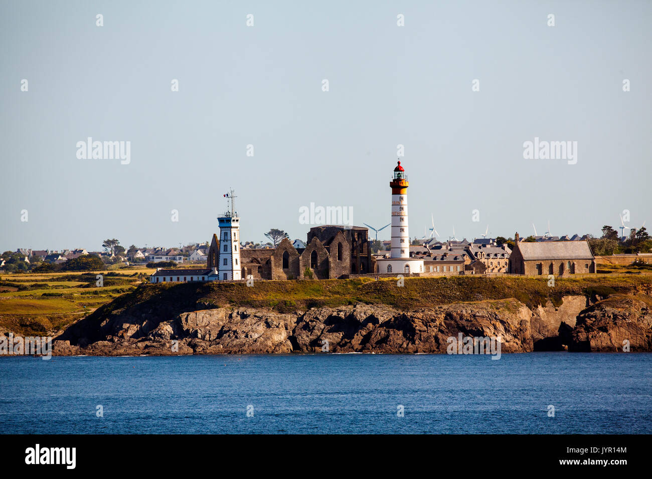 View of the Brittany headlands and the Abbaye Saint-Mathieu de fine Terre and Saint-Mathieu lighthouse seen from a ship in the Bay of Biscay France Stock Photo