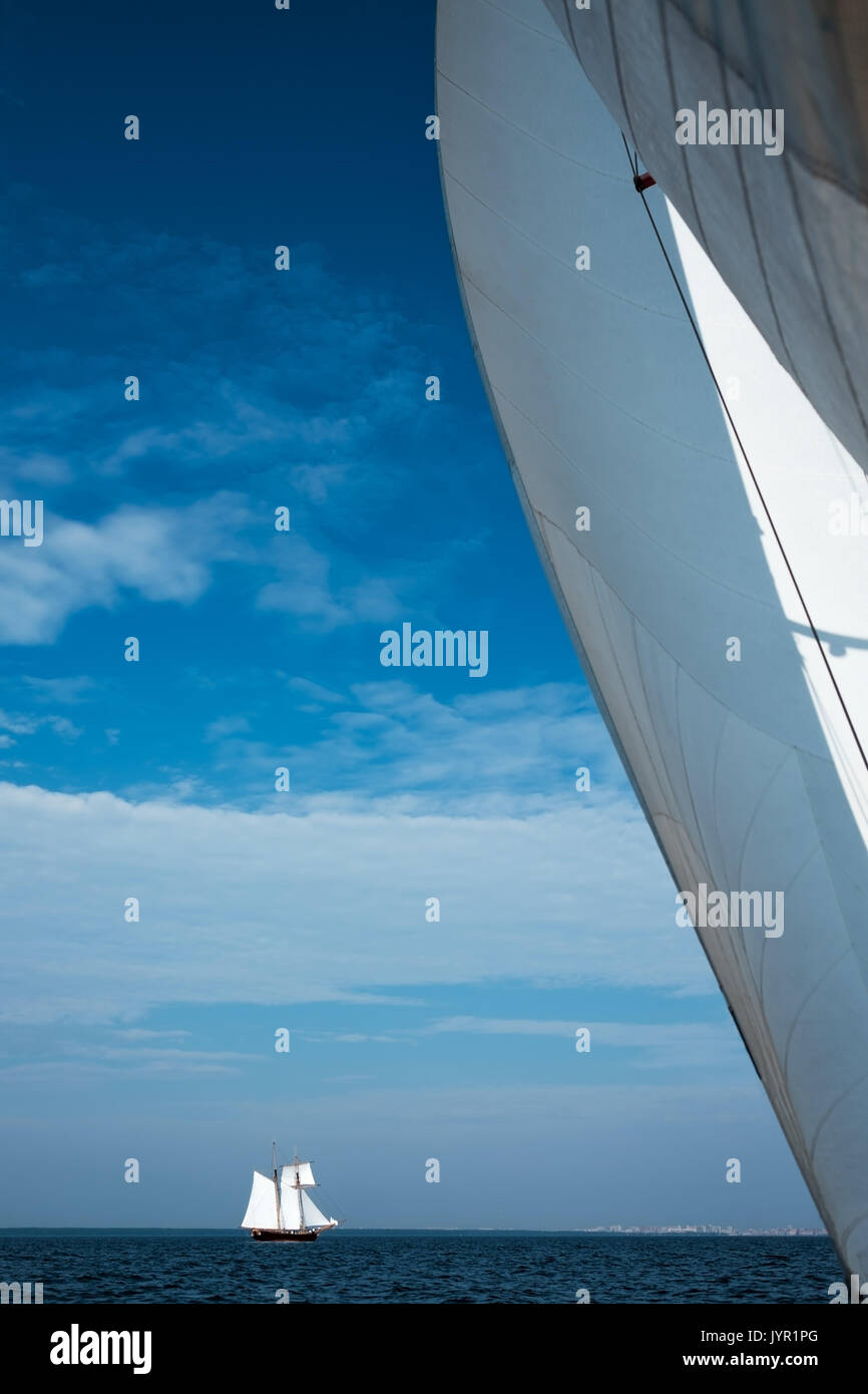 White sail yacht against the blue sky and the sea. Stock Photo