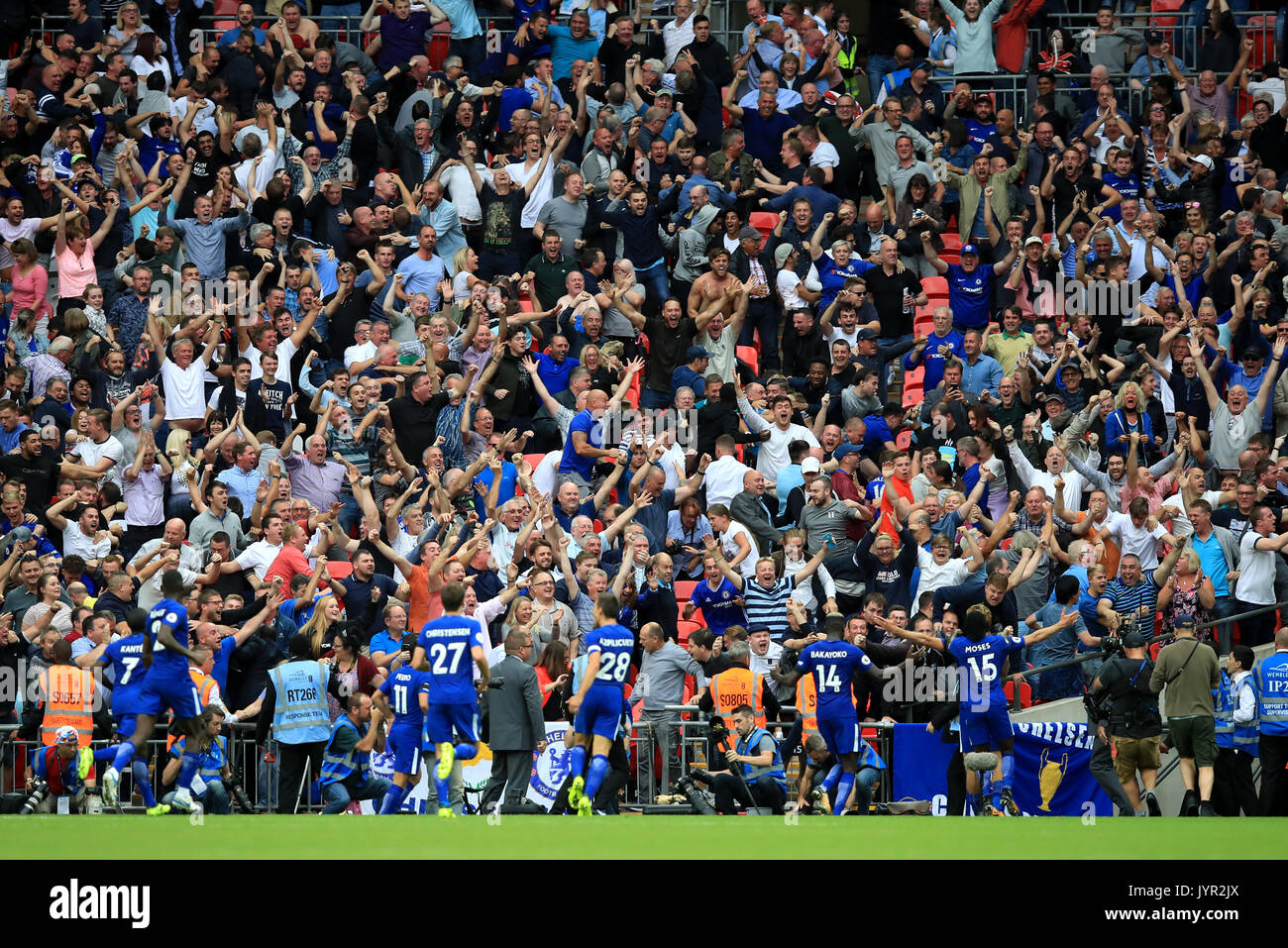 Chelsea fans celebrate in the stands as Chelsea's Marcos Alonso celebrates  scoring his side's second goal of the game with teammates during the  Premier League match at Wembley Stadium, London Stock Photo -