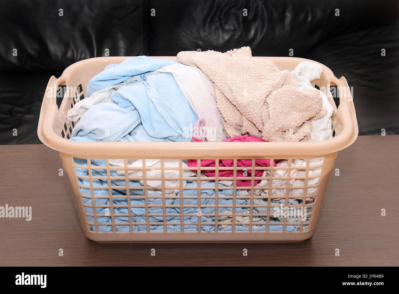 Clean wet laundry pile inside plastic basket Stock Photo Alamy
