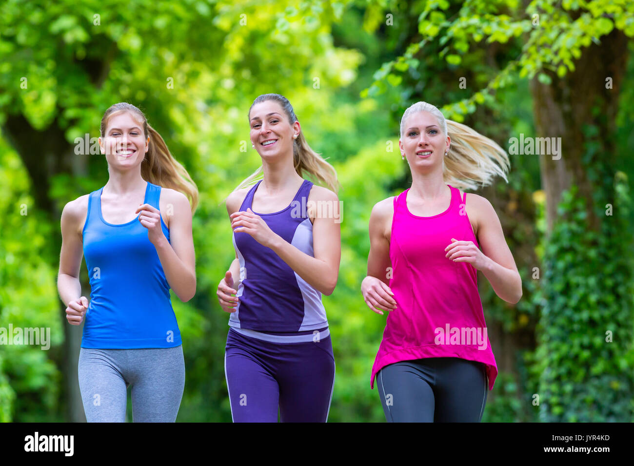 Women in forest running for sport Stock Photo