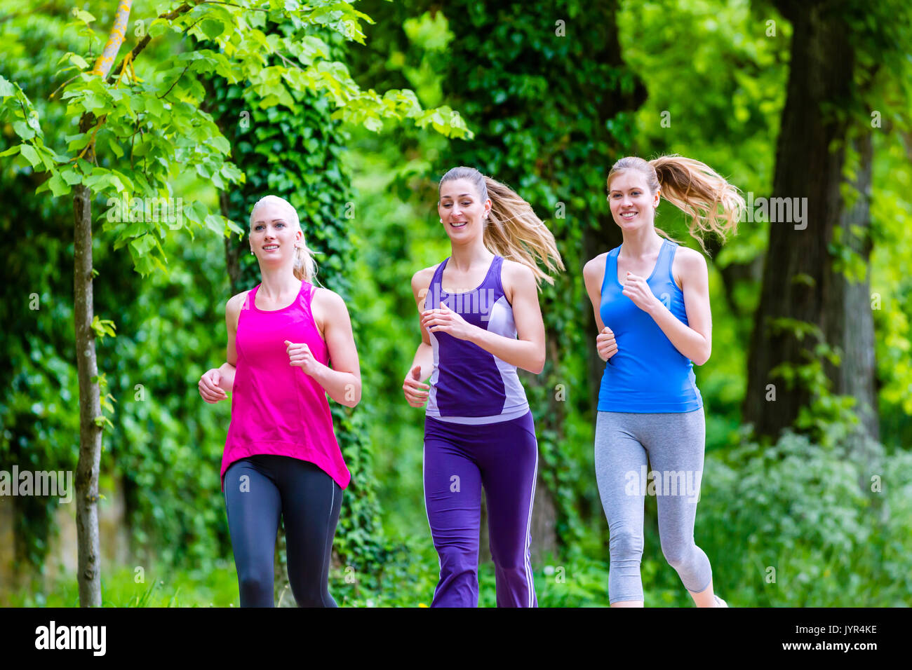 Women in forest running for sport Stock Photo