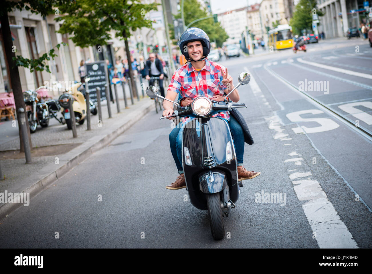 Scooter driver in the streets of Berlin Stock Photo Alamy