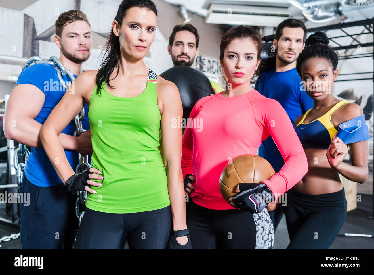 Group of women and men in gym posing at fitness training Stock Photo ...