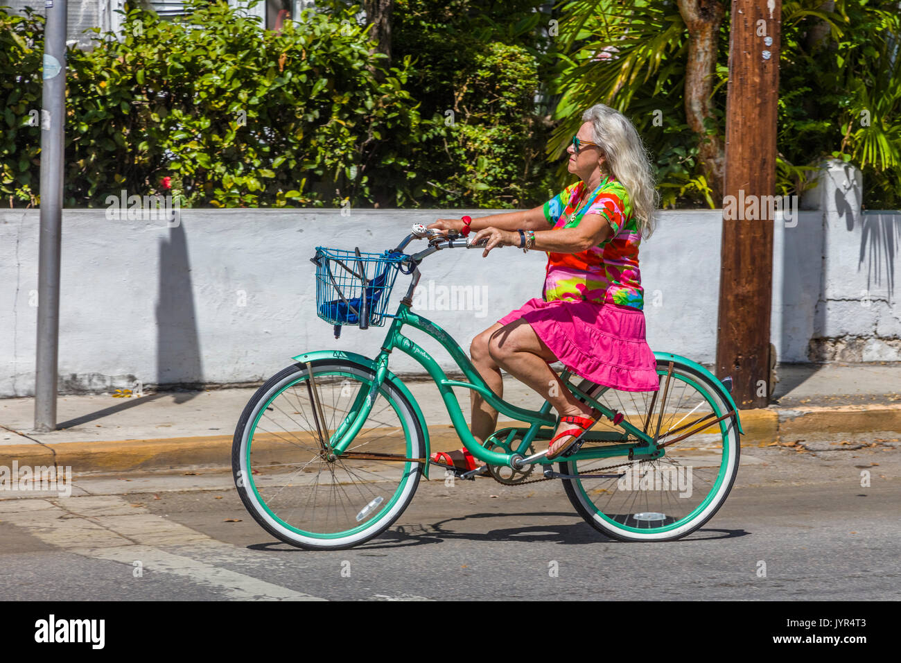 Colorful dressed woman riding bike in Key West Florida Stock Photo Alamy