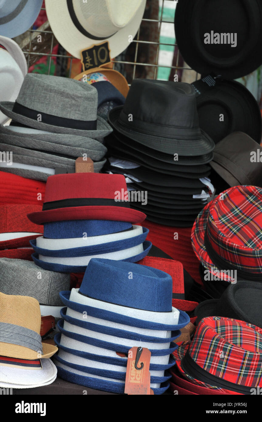 a selection variety of hats for sale trilbys and Stetsons caps and berets pork pies and bowlers at a fair or in the market place stalls hats. Stock Photo