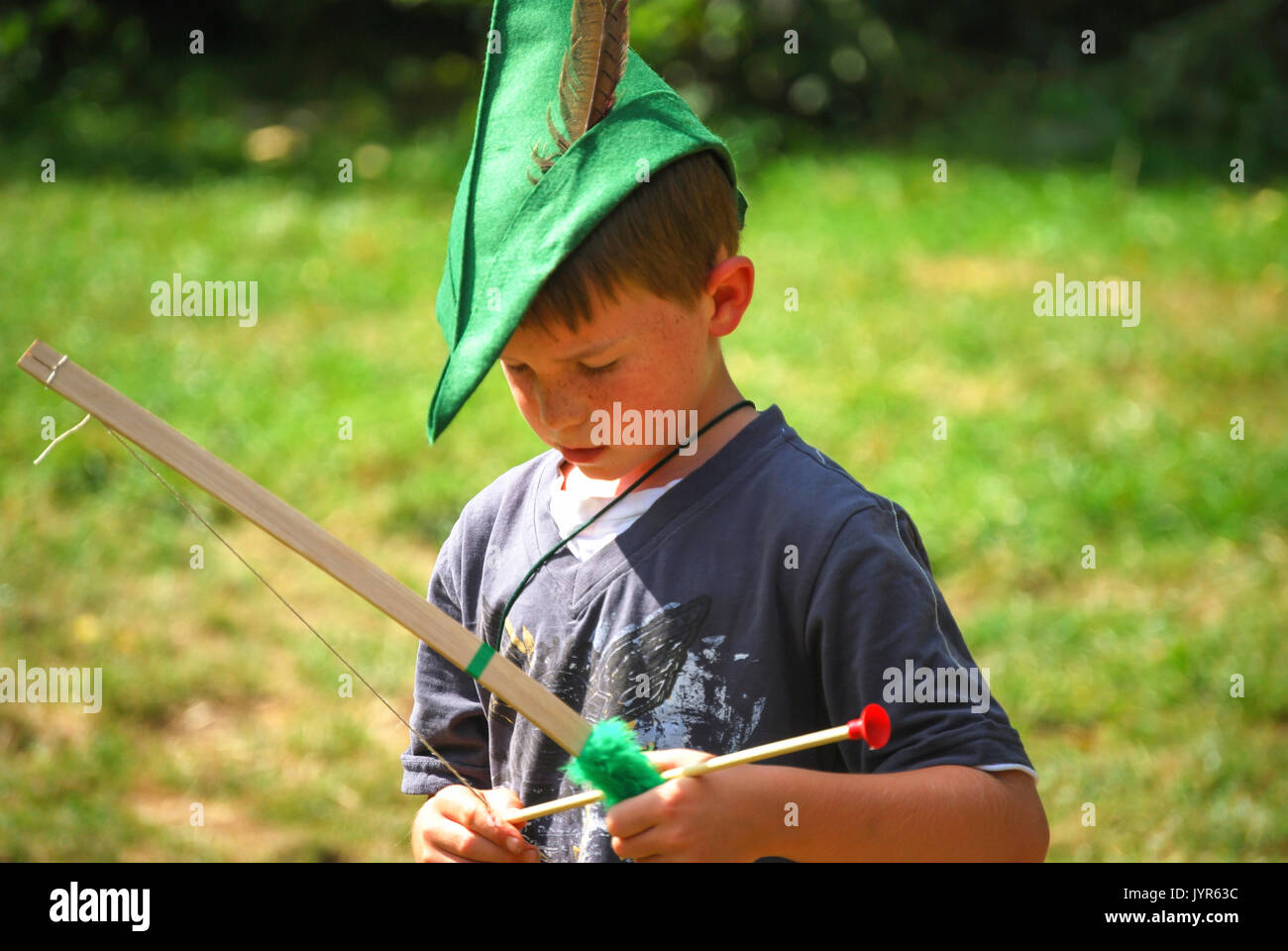 Boy with green hat, bow and arrow, Robin Hood Festival, Sherwood Forest, Nottinghamshire, England, United Kingdom Stock Photo