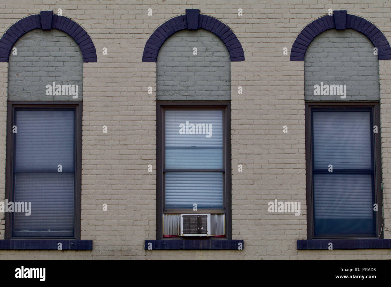 Three windows from a nineteenth century brick building Stock Photo