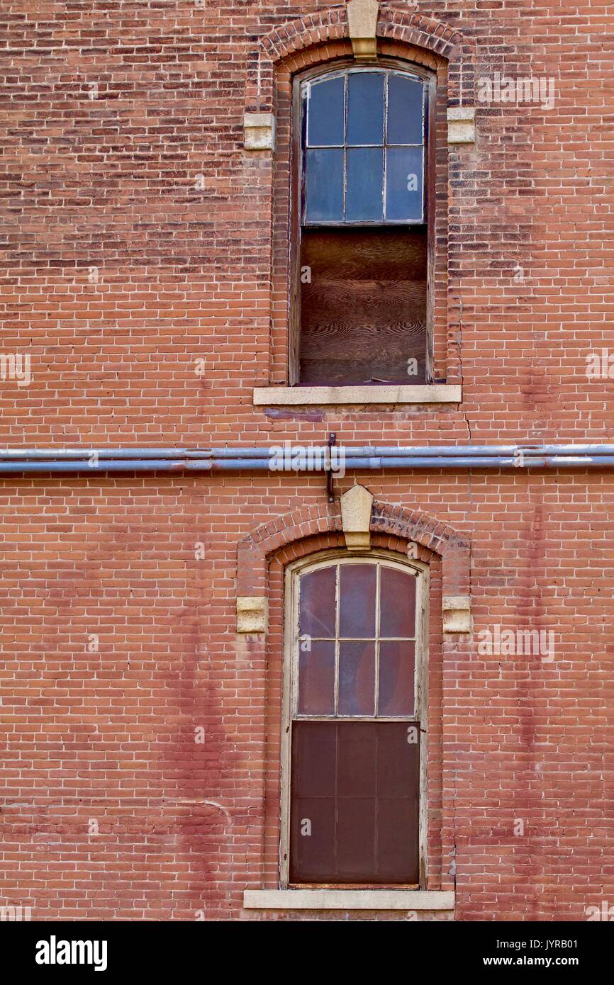 Old brick flour mill with vintage windows Stock Photo