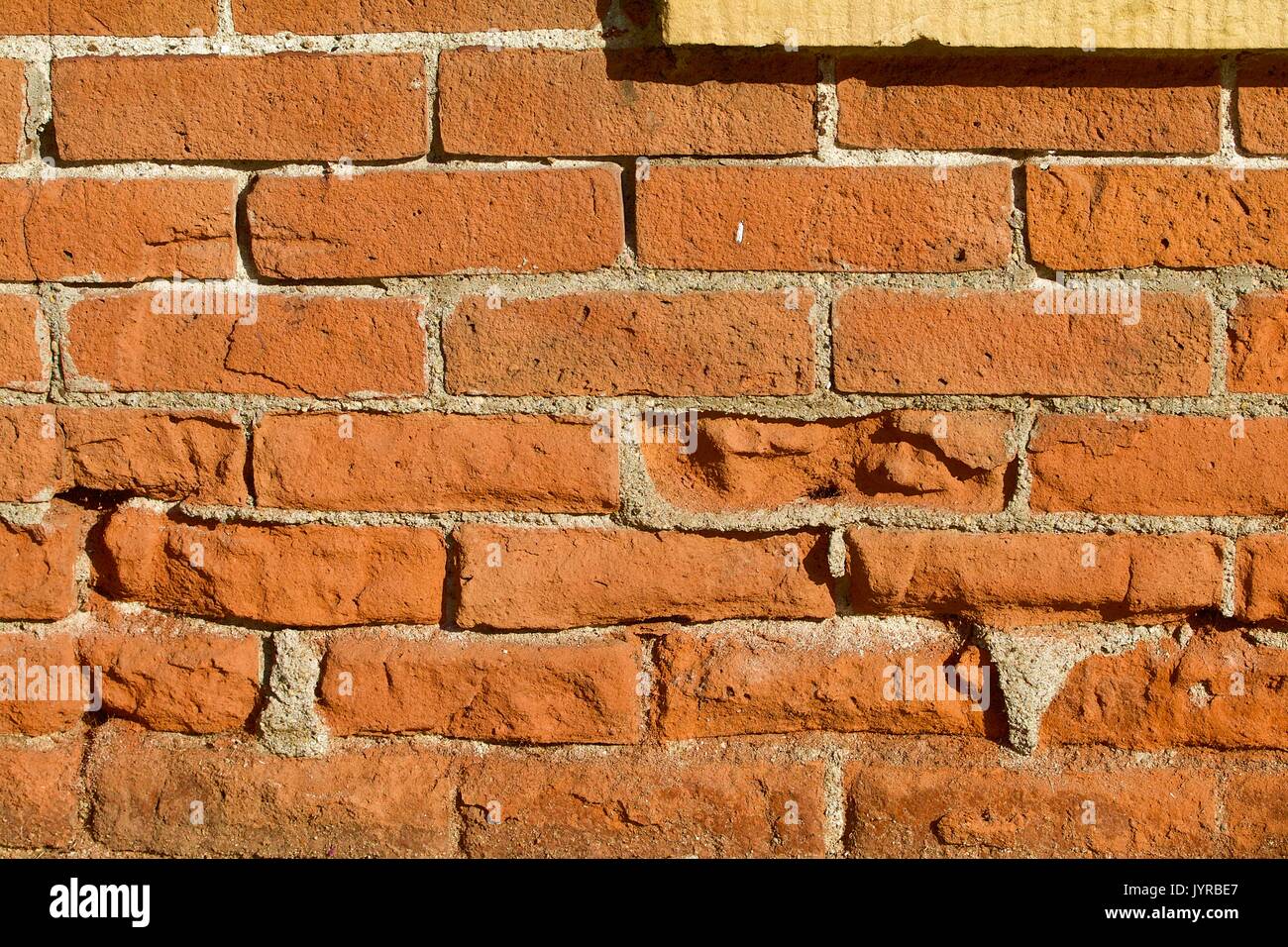 Nineteenth century brick wall with limestone frame Stock Photo