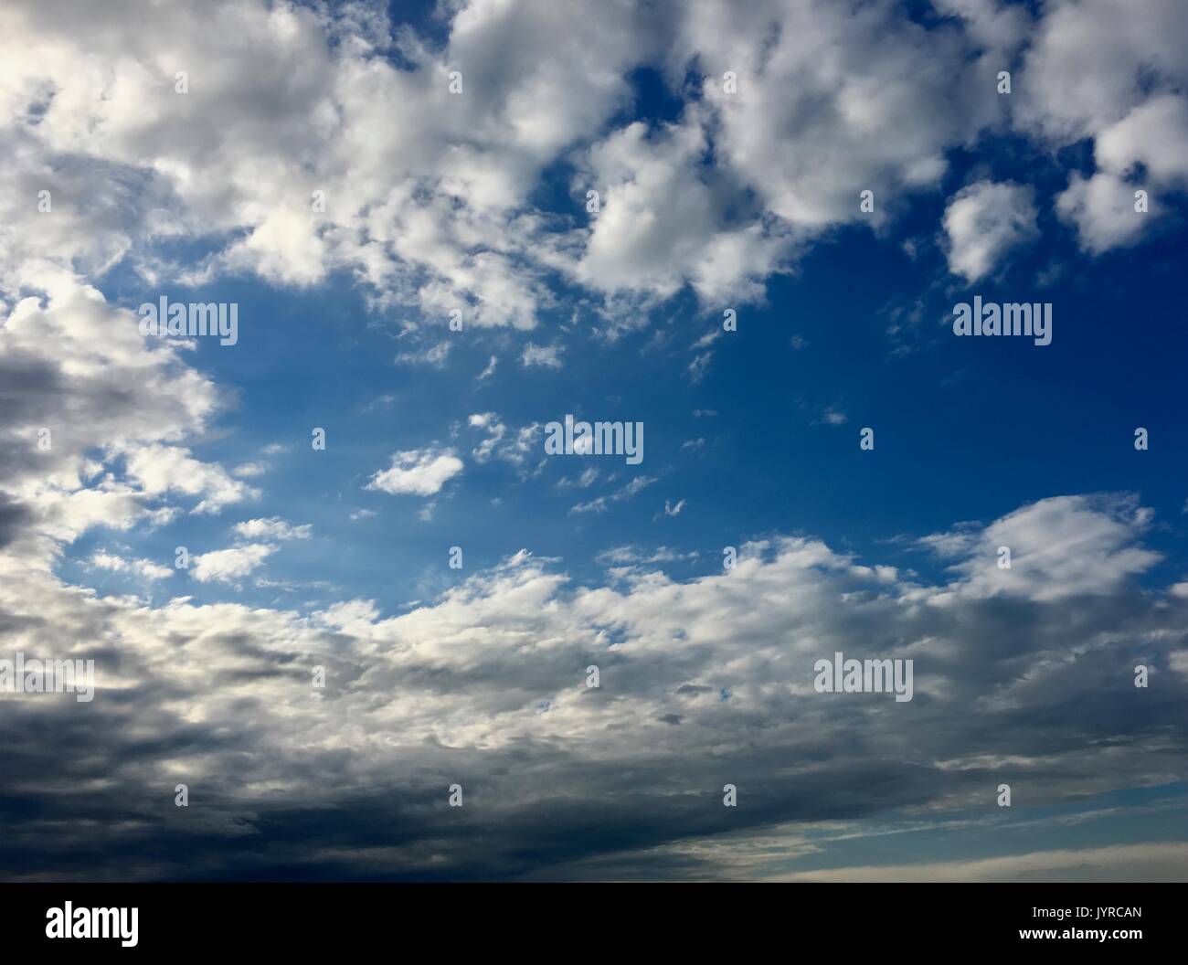 Wide azure evening sky and altocumulus clouds Stock Photo