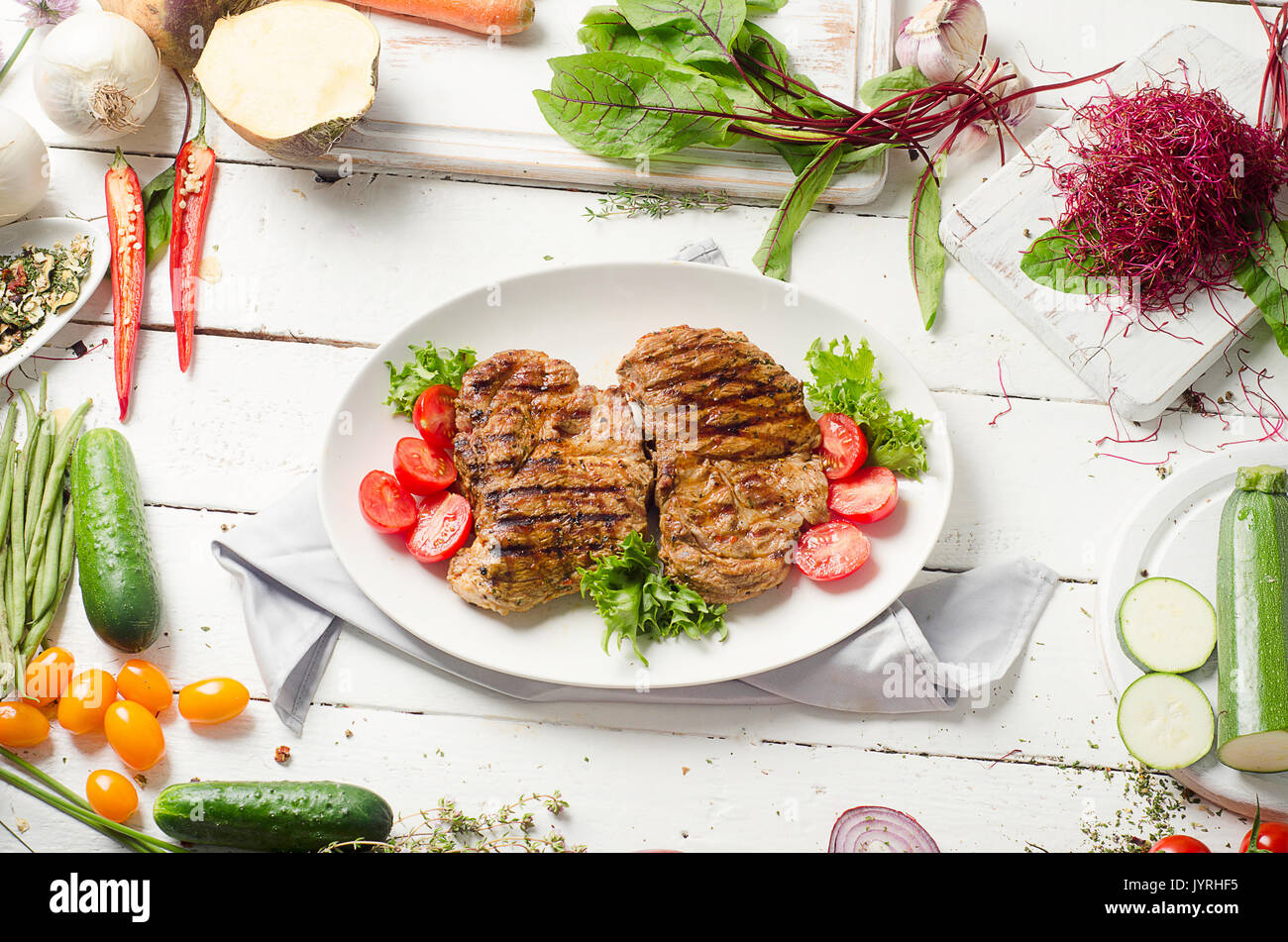 grilled-pork-steak-and-fresh-vegetable-salad-stock-photo-alamy