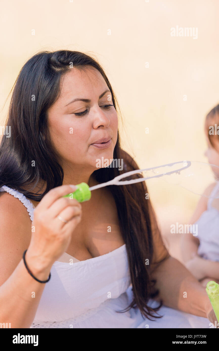 Playing with soap bubbles in the park Stock Photo - Alamy