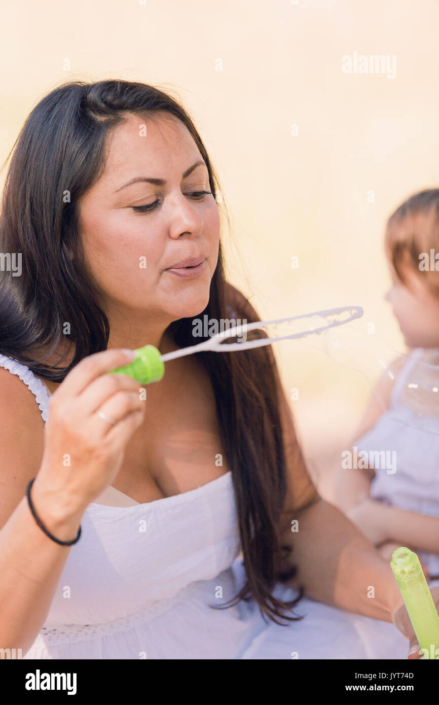 Playing with soap bubbles in the park Stock Photo - Alamy