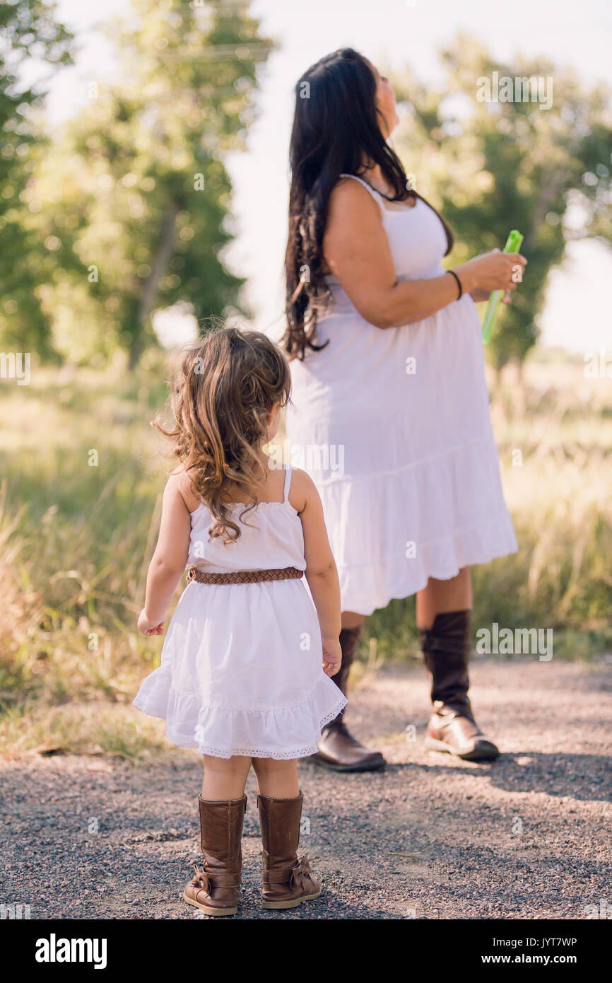 Little girl in a white sun dress at the family photo shoot Stock Photo