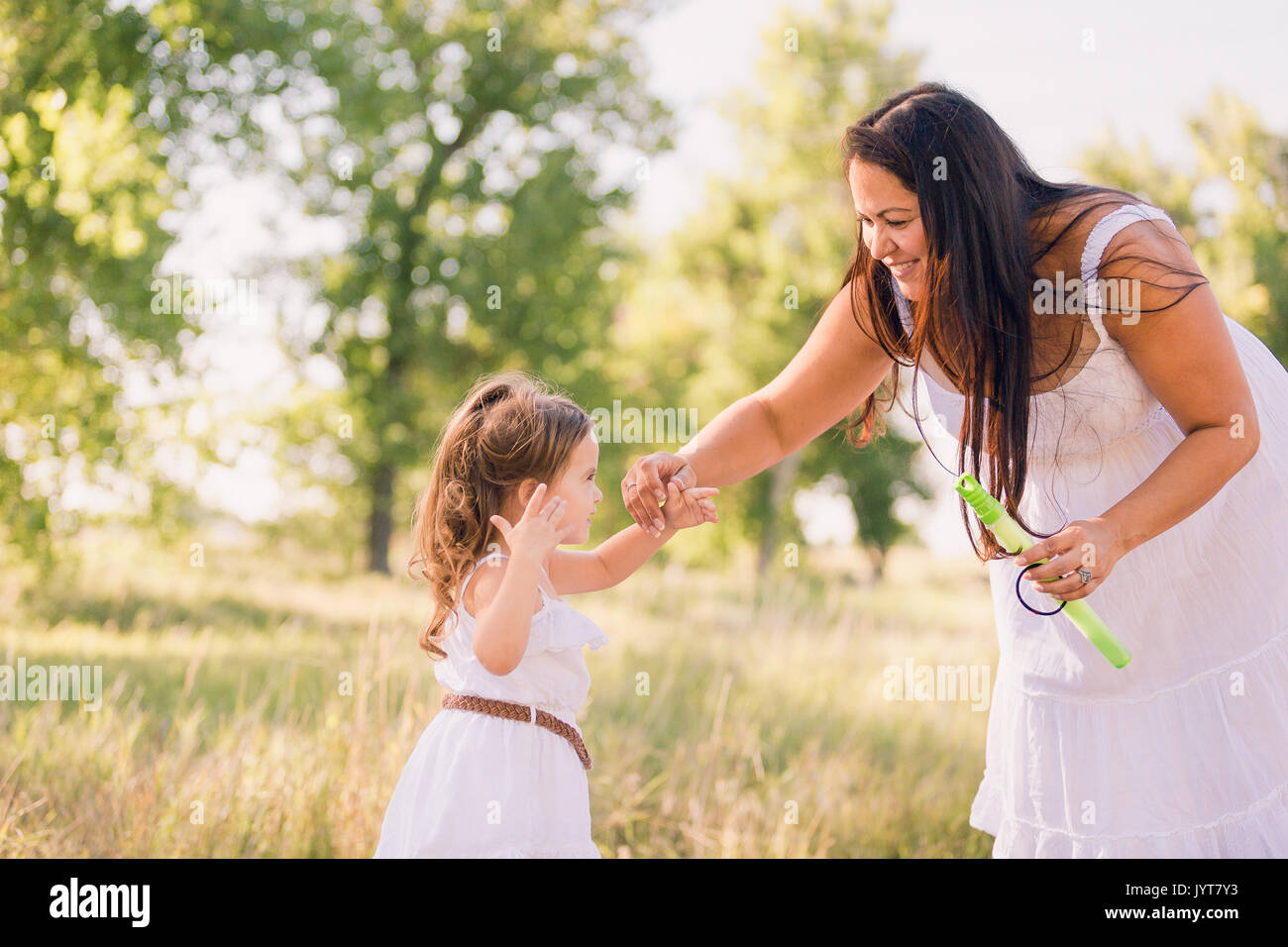Playing with soap bubbles in the park Stock Photo - Alamy