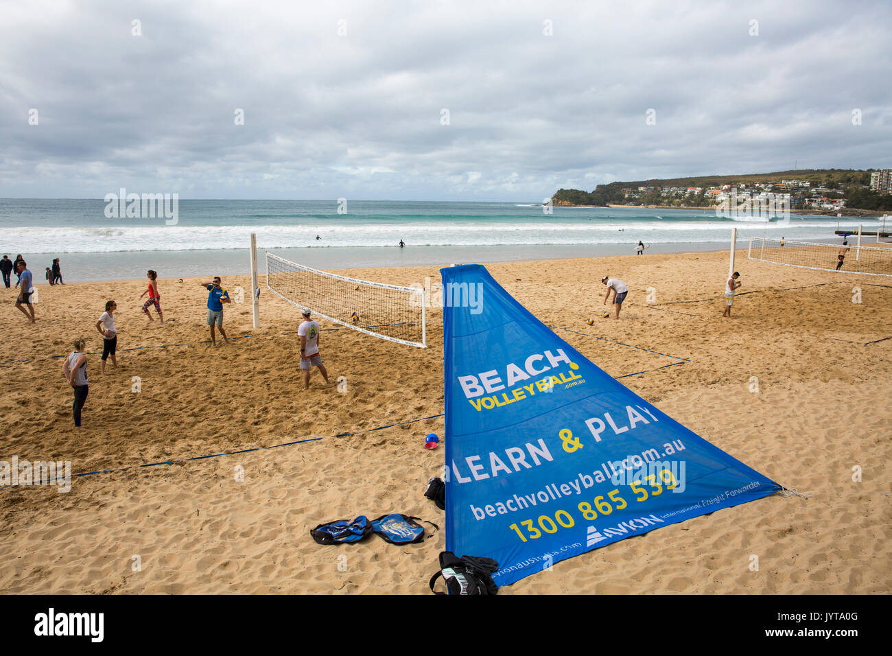 People playing and learning beach volleyball on Manly beach on a winters day,Sydney,Australia Stock Photo