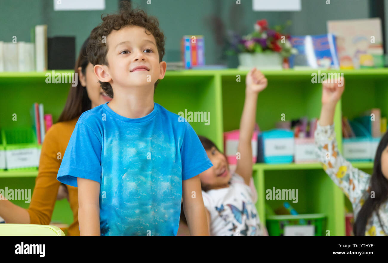 Kindergarten students stand up in classroom,preschool international education concept. Stock Photo
