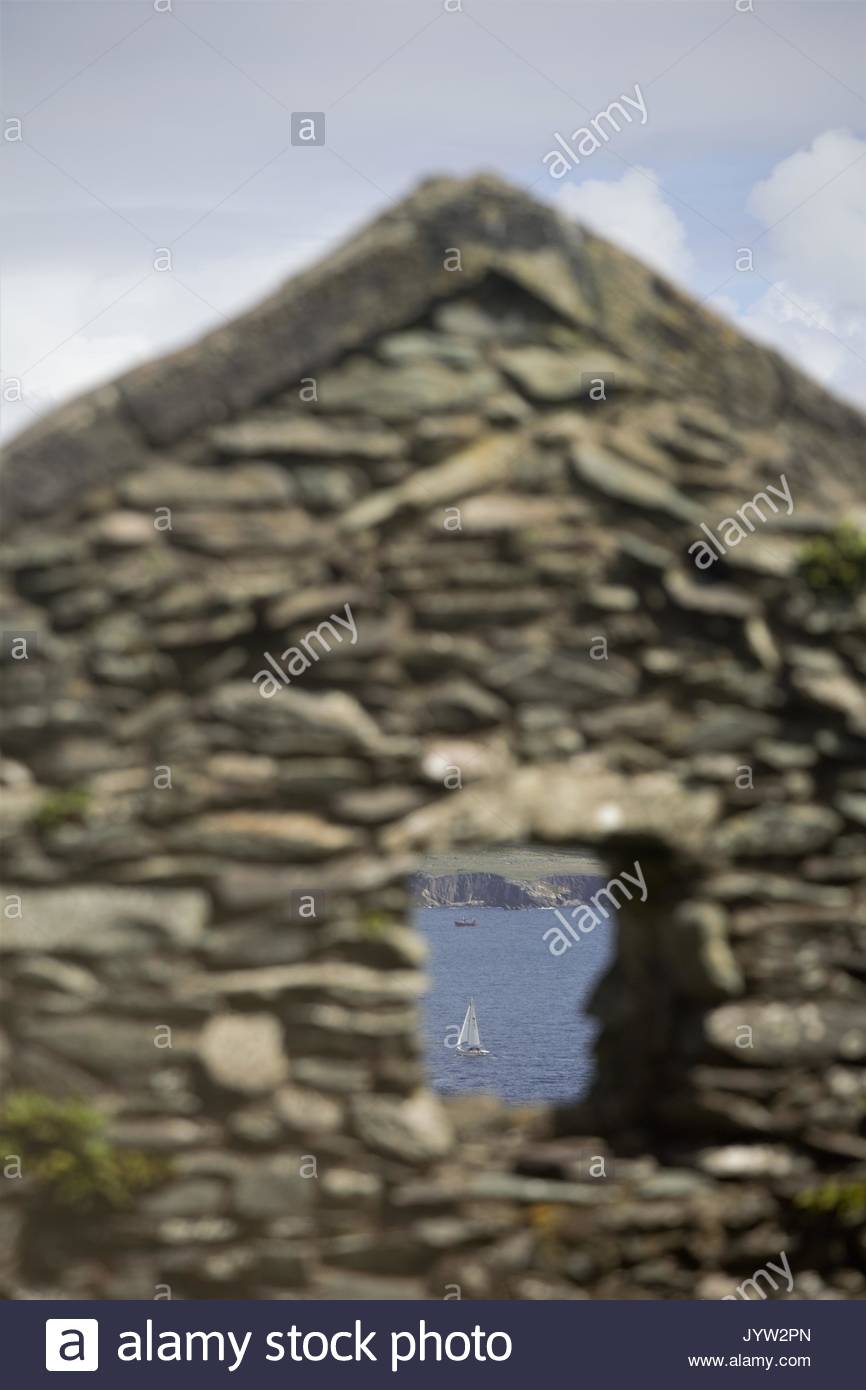 A view of through a window on the Blasket Island off the west coast of Ireland in a stone house in which people once lived. Stock Photo