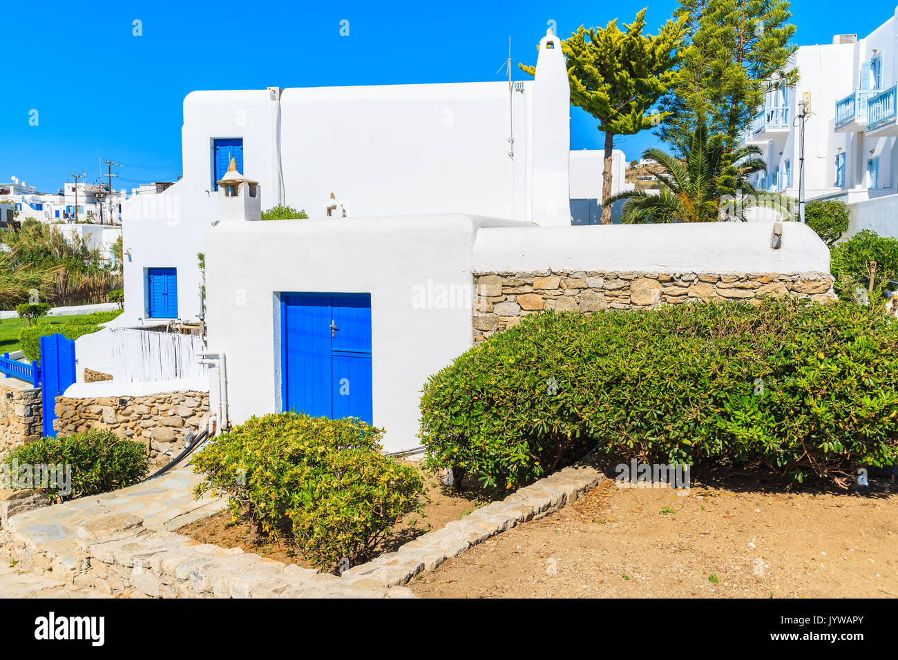 Front view of typical white house with blue windows in Mykonos town, Mykonos island, Greece Stock Photo