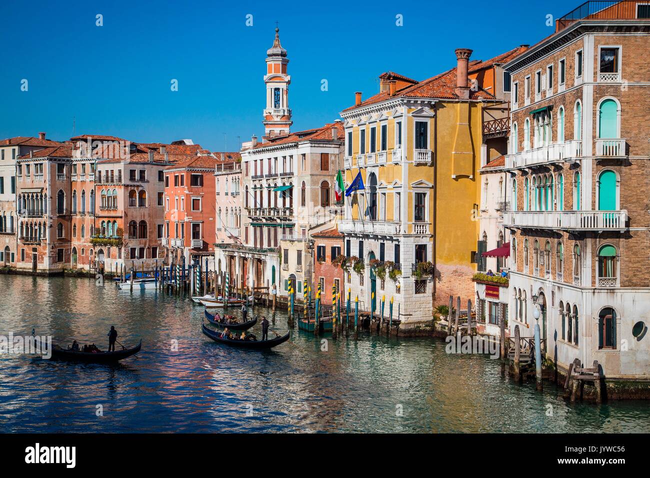 Venice, Veneto, Italy. Sunny view of some Venice canal, with goondolas passing trough. Stock Photo
