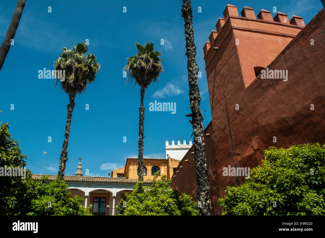 Architectural details and view of the gardens of Patio de la Alcubilla, a courtyard of the Alcazar of Seville, royal palace of mudejar architecture Stock Photo