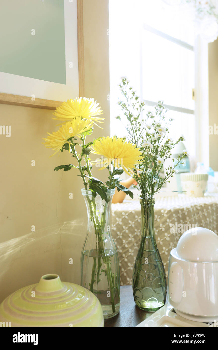 two glass vases of chrysanthemum and gypsophila put in a home Stock Photo