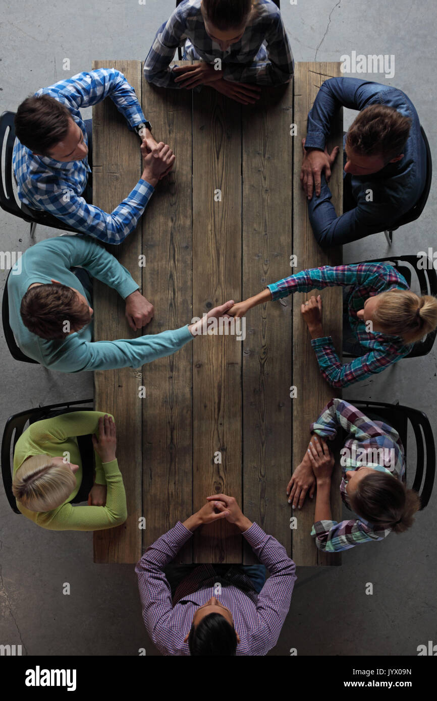 Hipster business people shaking hands, teamwork on new business concept Stock Photo