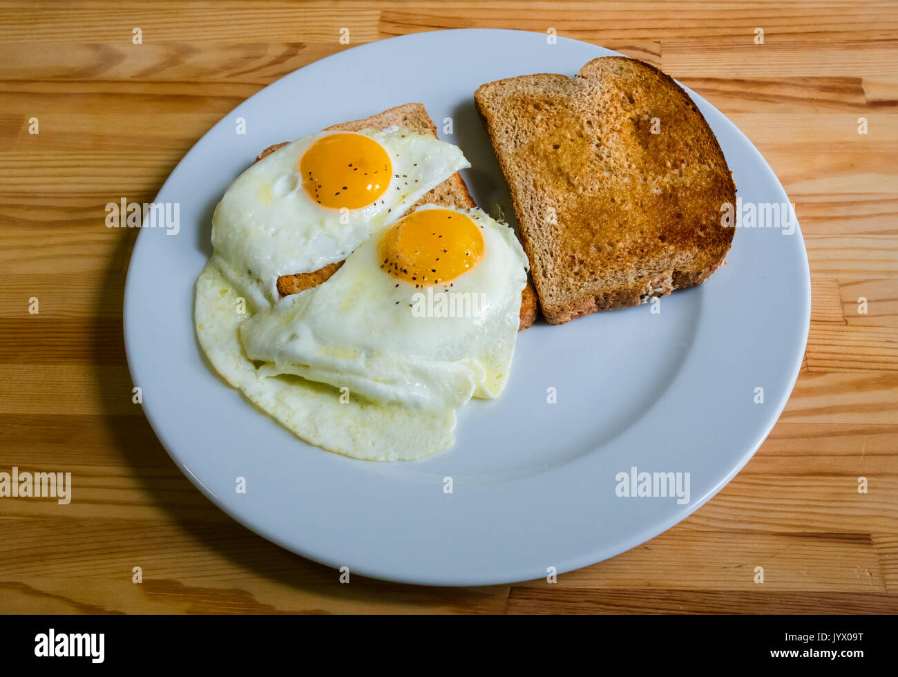 Two fried eggs sunny side up and whole wheat toast Stock Photo Alamy