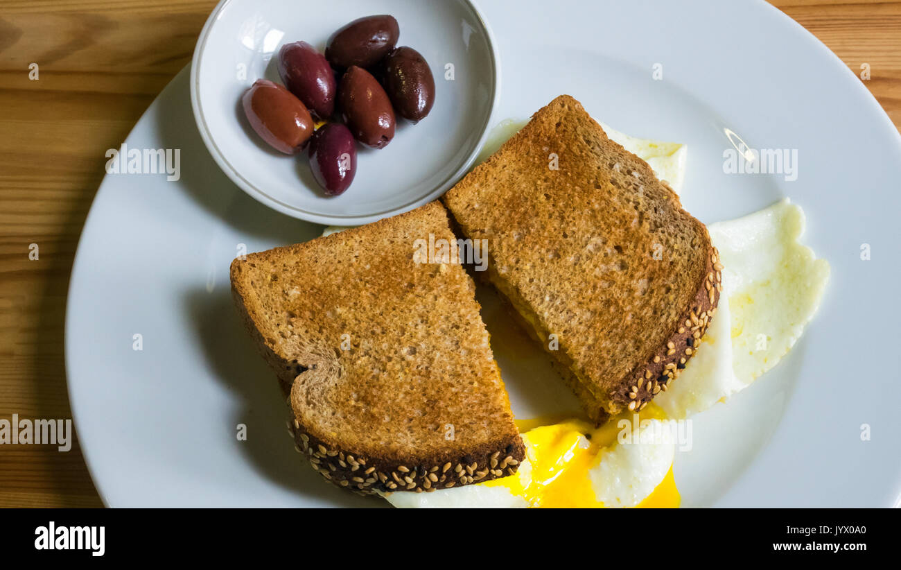 An egg sandwich on whole wheat toast with olives Stock Photo Alamy