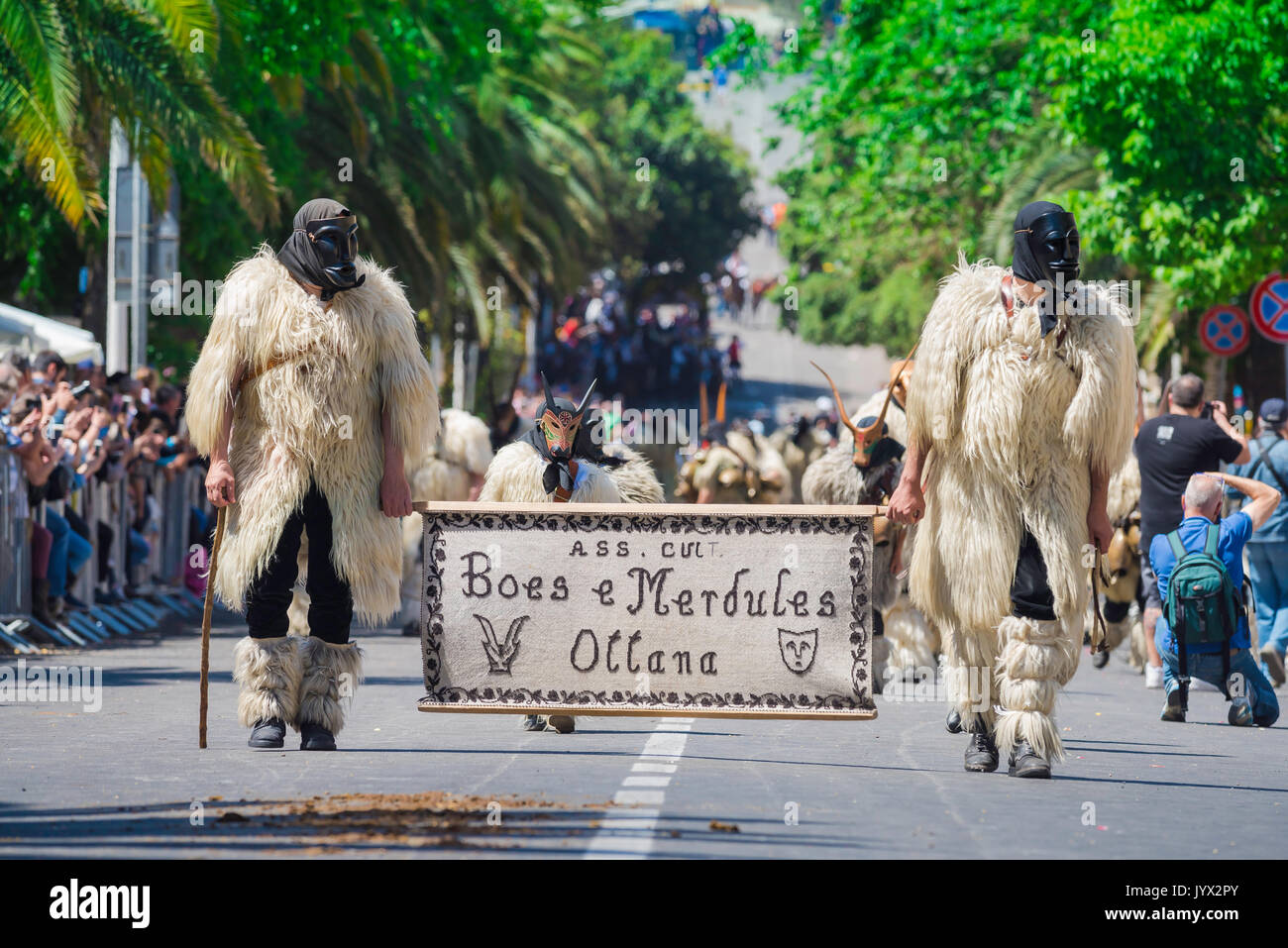 Sardinia traditional festival, men dressed as Boes and Merdules - traditional figures in sheepskins and masks, participate in La Cavalcata, Sassari. Stock Photo