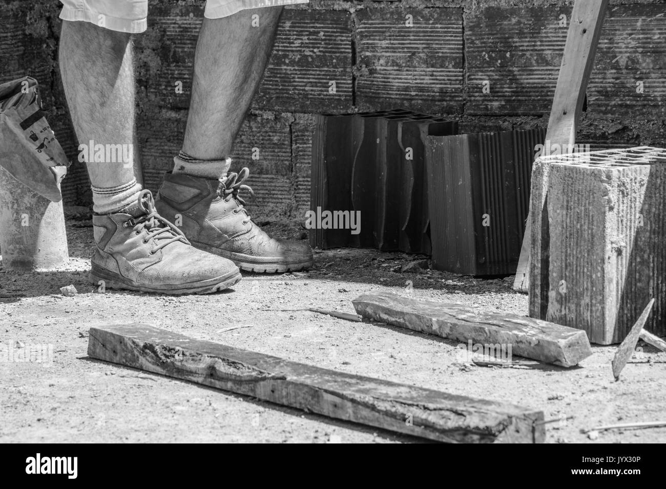 Bricklayer in the construction site Stock Photo