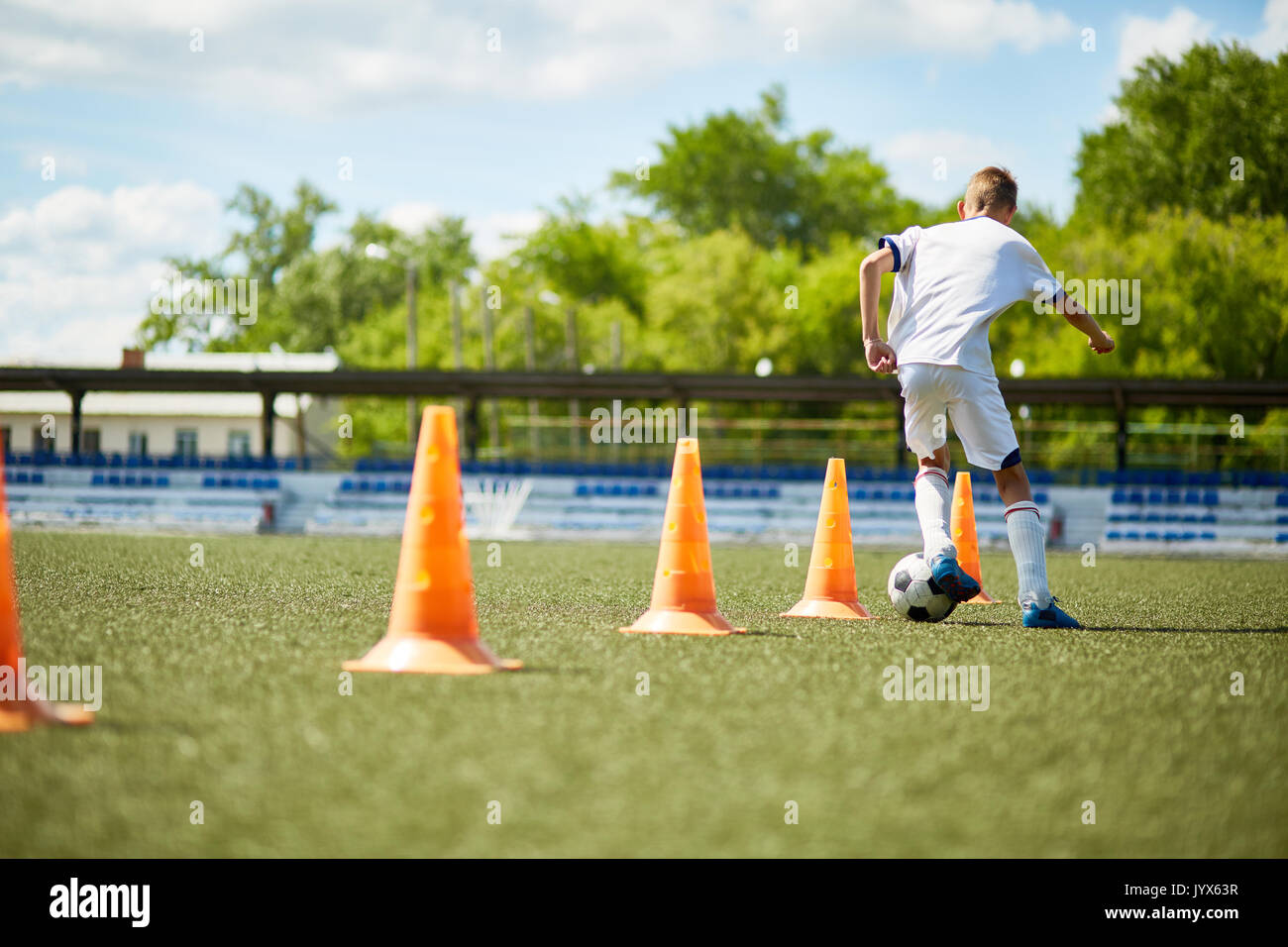 Boy Training for Football Game Stock Photo