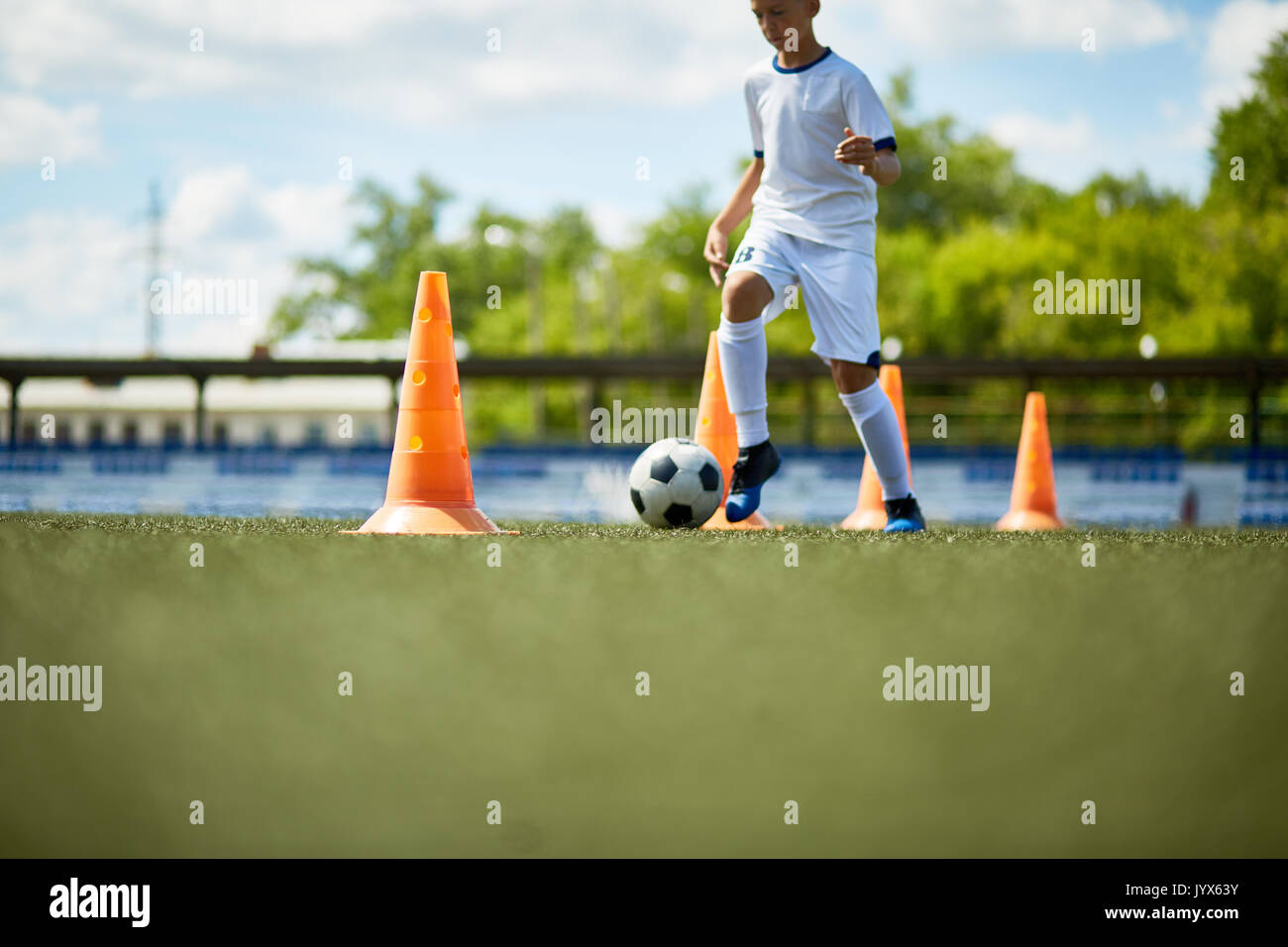 Boy Training in Football Field Stock Photo