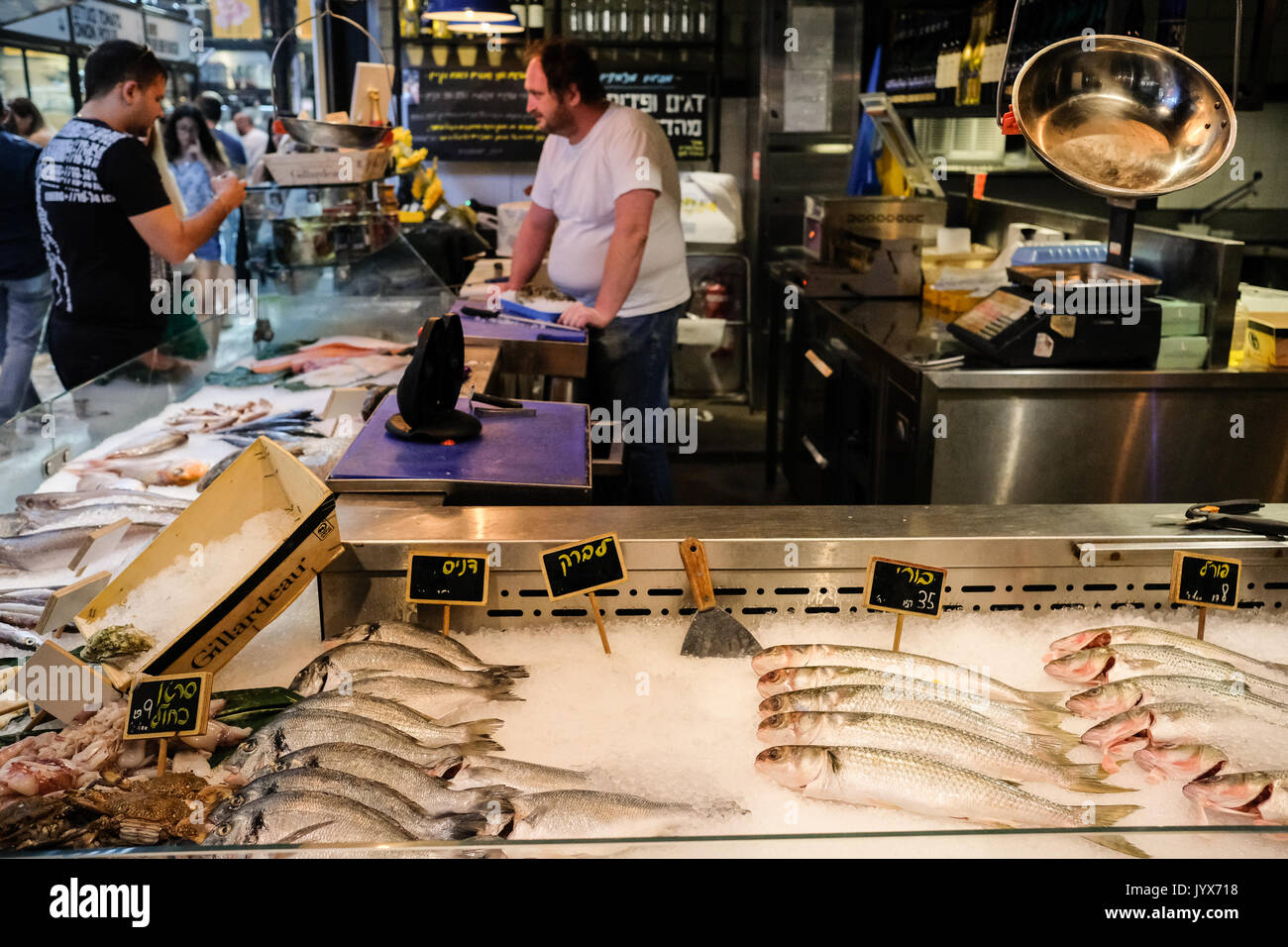 People purchase fresh fish at a fish and seafood shop offering