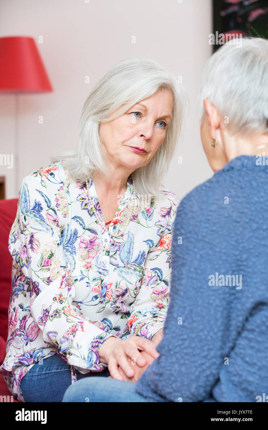 Older woman comforts her friend Stock Photo
