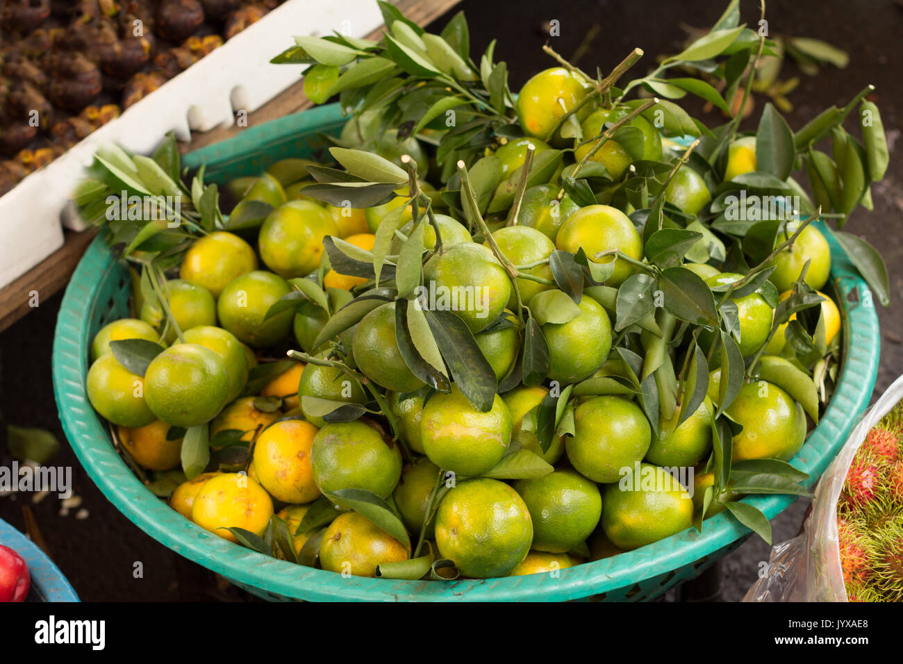 basket full of green tangerines Stock Photo