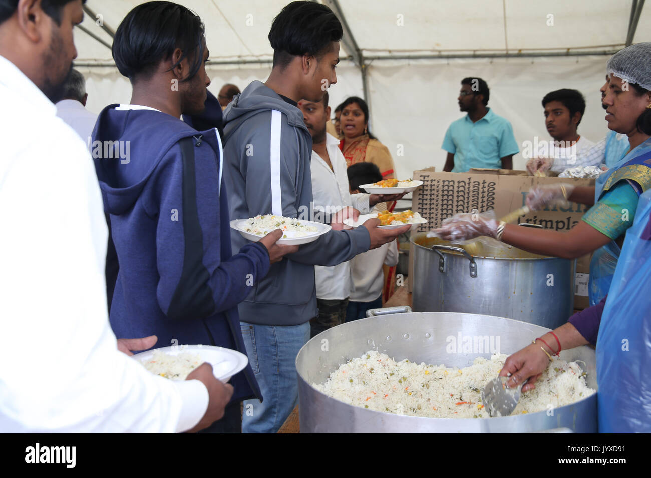 London, UK. 20th Aug, 2017. The London Sri Murgan Temple in East London celebrated the Chariot festival, crowds come back to the temple were free food of rice curry and potatos were served free of charge, people sat along the temple walls to eat it Credit: Paul Quezada-Neiman/Alamy Live News Stock Photo