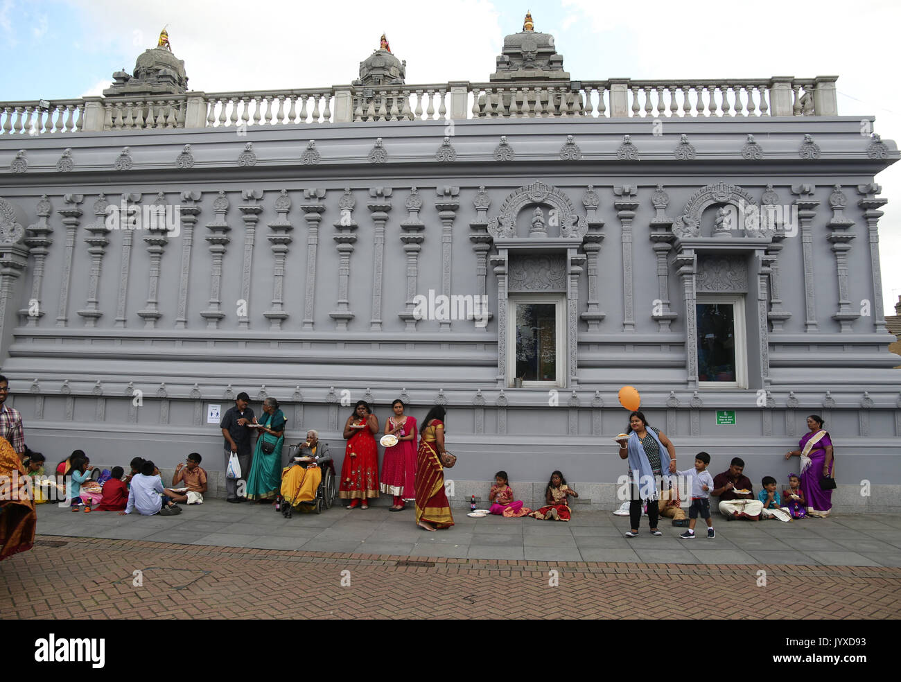 London, UK. 20th Aug, 2017. The London Sri Murgan Temple in East London celebrated the Chariot festival, crowds come back to the temple were free food of rice curry and potatos were served free of charge, people sat along the temple walls to eat it Credit: Paul Quezada-Neiman/Alamy Live News Stock Photo