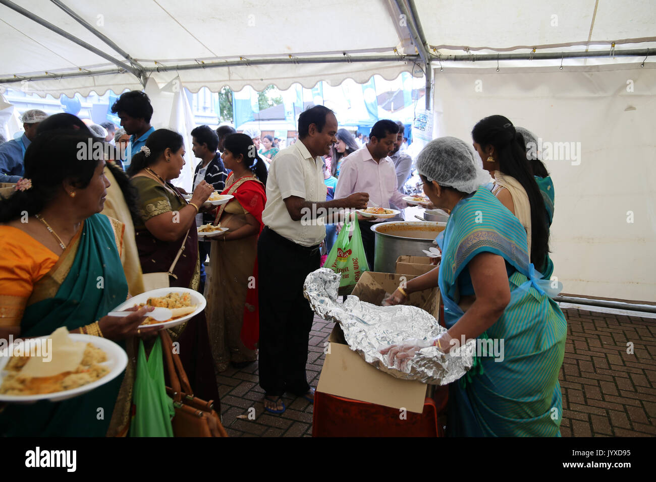 London, UK. 20th Aug, 2017. The London Sri Murgan Temple in East London celebrated the Chariot festival, crowds come back to the temple were free food of rice curry and potatos were served free of charge, people sat along the temple walls to eat it Credit: Paul Quezada-Neiman/Alamy Live News Stock Photo
