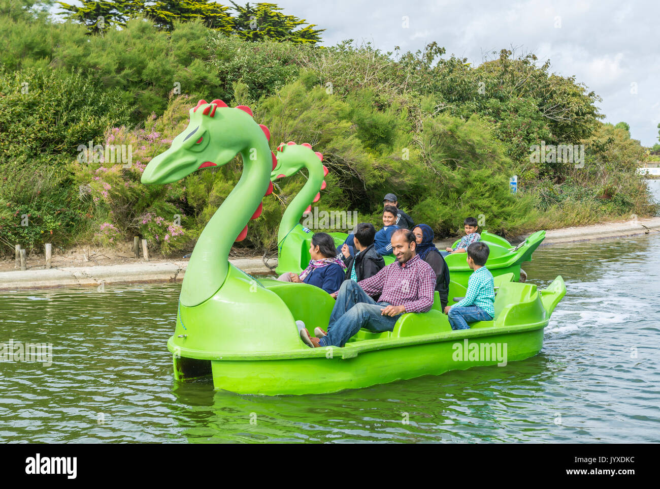 Mewsbrook Park, Littlehampton, West Sussex, England, UK. Sunday 20th August 2017. UK Weather. A family enjoy riding on a pedelo on the boating lake at Mewsbrook Park in Littlehampton this afternoon. The weather is cloudy but fairly warm and dry, near the south coast of England. Credit: Geoff Smith/Alamy Live News Stock Photo